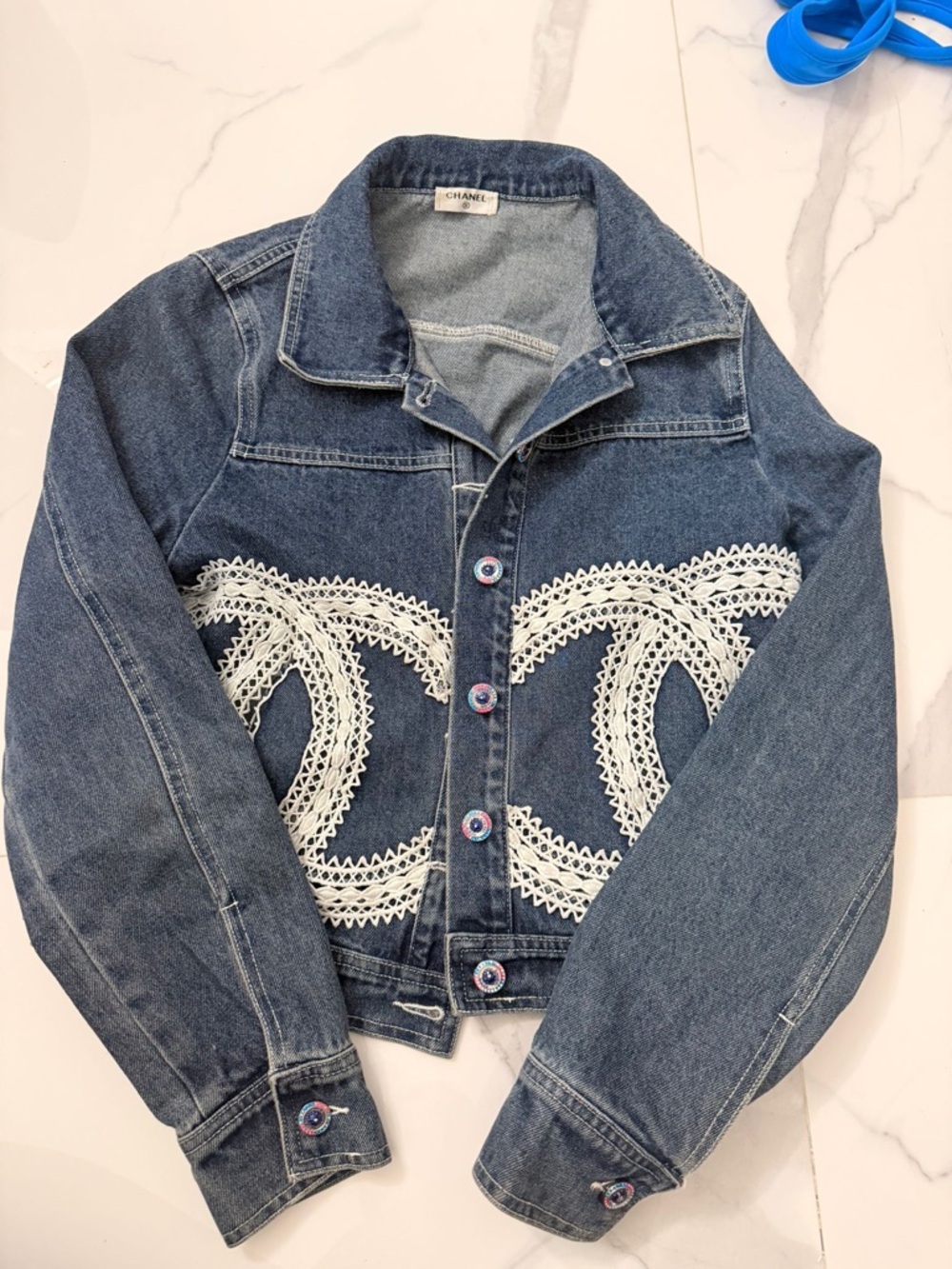 CHANEL Blue Denim Jacket with White Crochet CC Logos